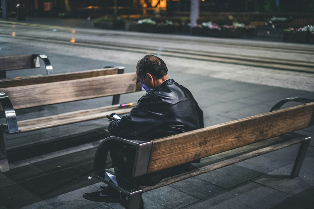 lonely person sitting on bench