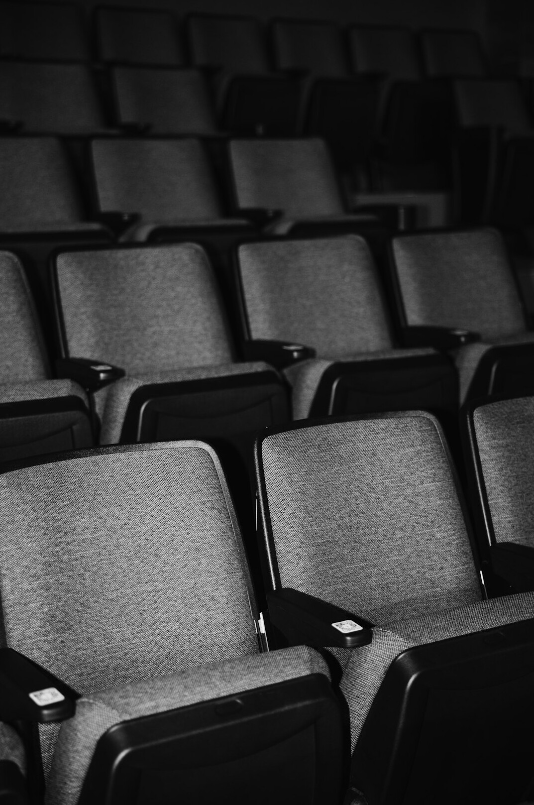 Rows of empty theater seats in soft light