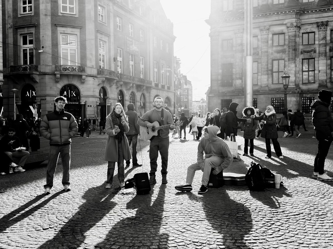 Anonymous silhouettes of people seen from a distance in a public square