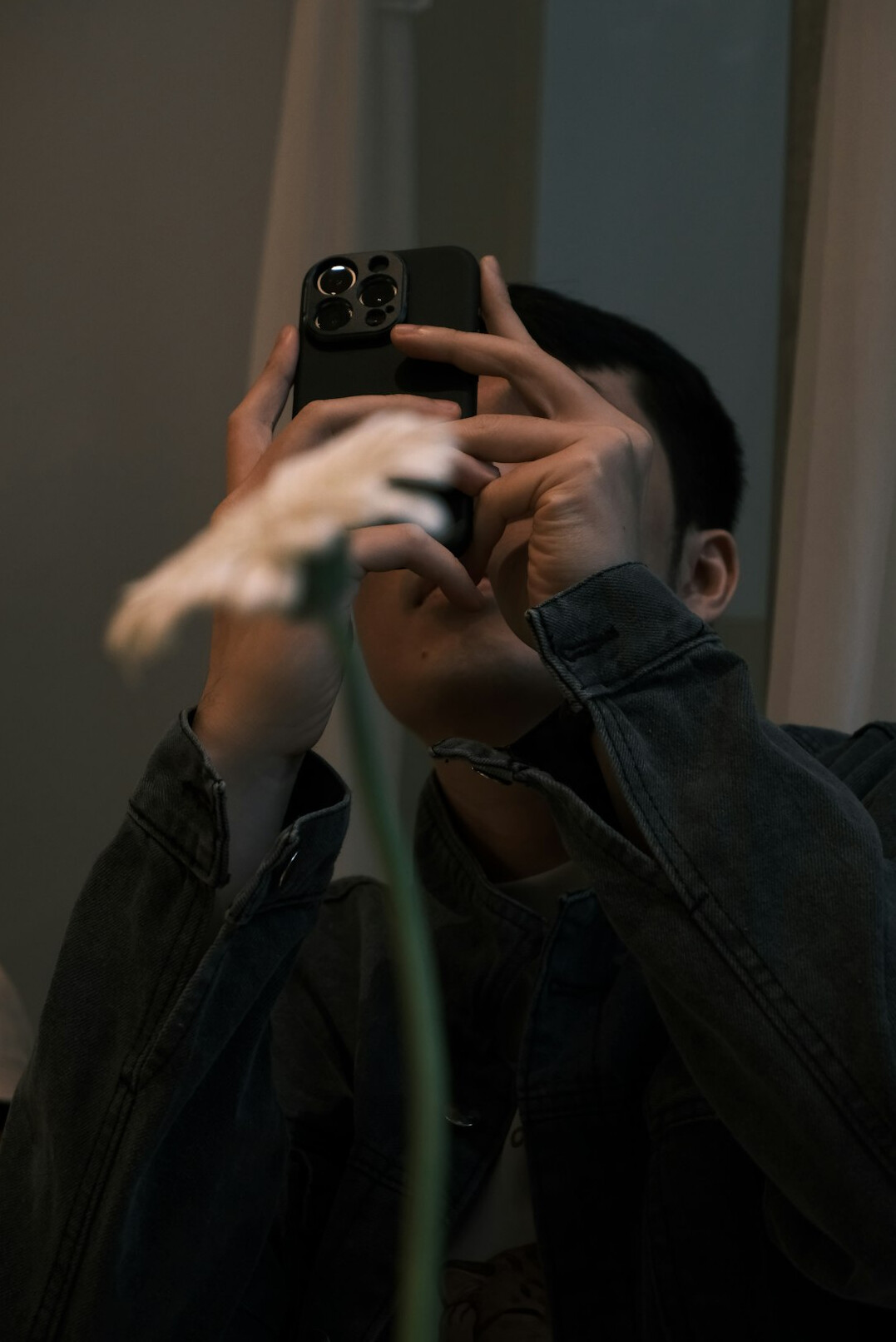 person looking in mirror with phone