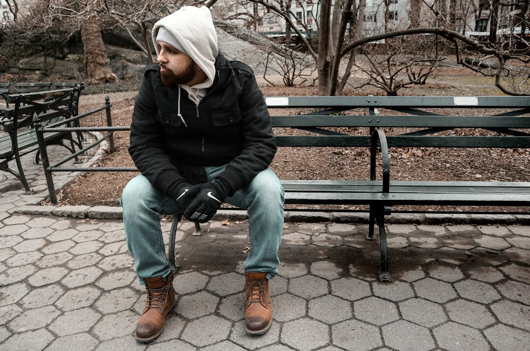 lonely person sitting on bench